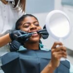 affordable dental consultation in Oceanside CA, low income dentist accepting Medi-Cal North County San Diego, patient discussing dental options without stress.
